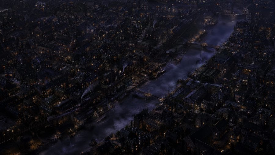 An aerial night view of a dense district of low buildings with a canal cutting diagonally